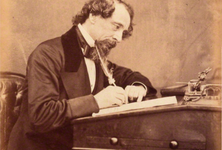 photo of charles dickens at a writing desk