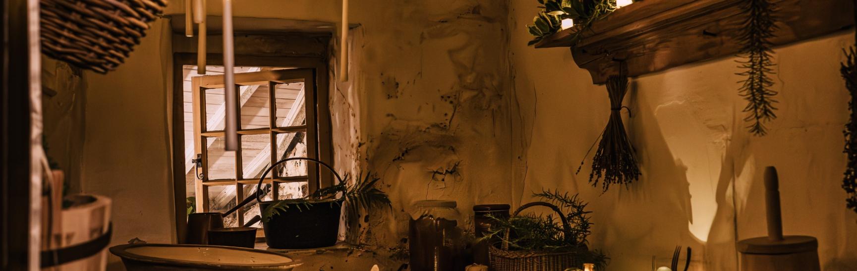 photo of an old fashioned larder filled with candles and greenery