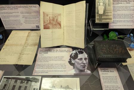 photo of various documents and photos in a display case