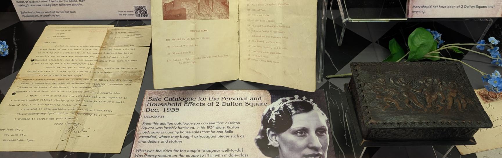 photo of various documents and photos in a display case