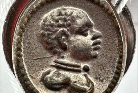 silver seal matrix with the image of a black person's head in profile.